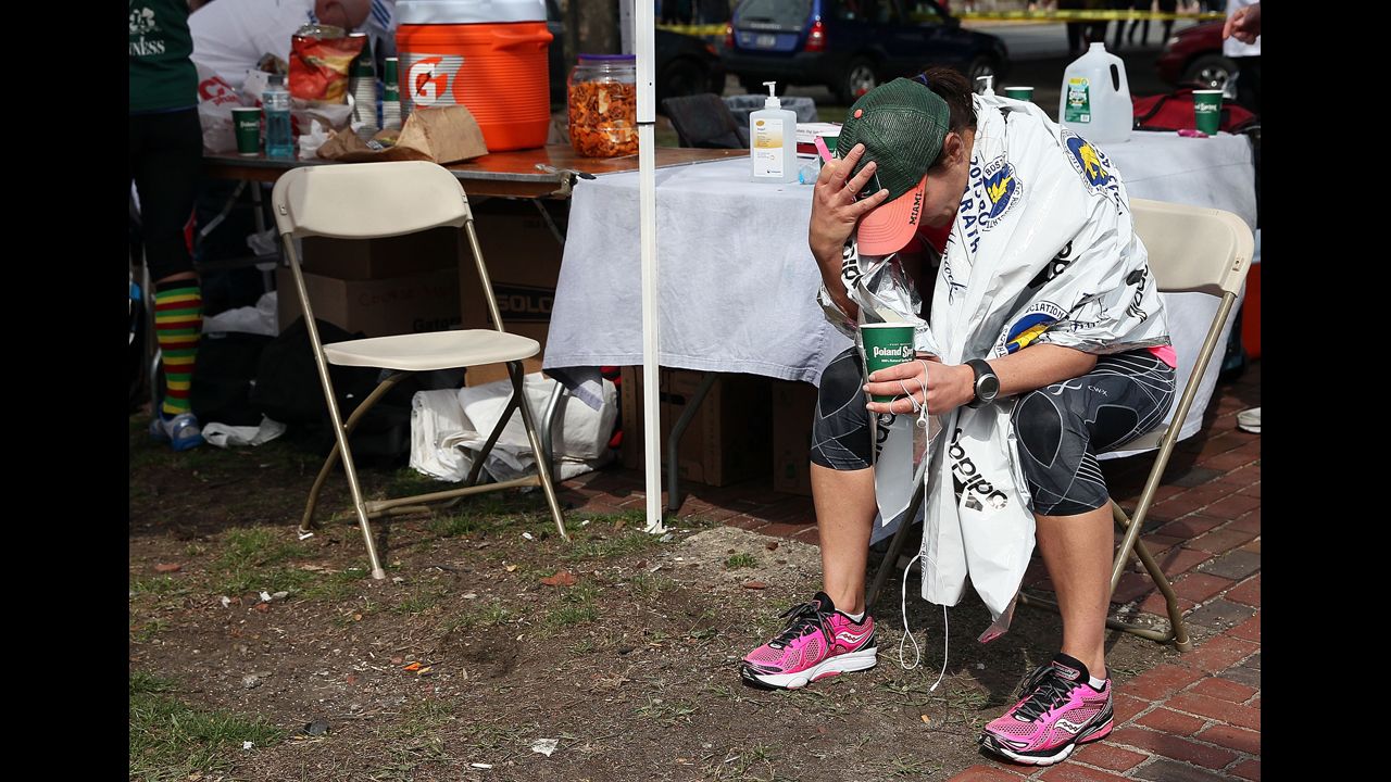 A runner sits near Kenmore Square after the attack.