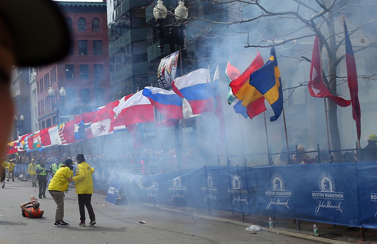 Officials watch as the first explosion goes off on Boylston Street.
