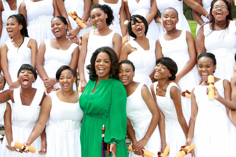 Oprah Winfrey poses with the graduates of the school she funded, the Oprah Winfrey Leadership Academy for Girls in Henley on Kilp, South Africa, in January 2012.