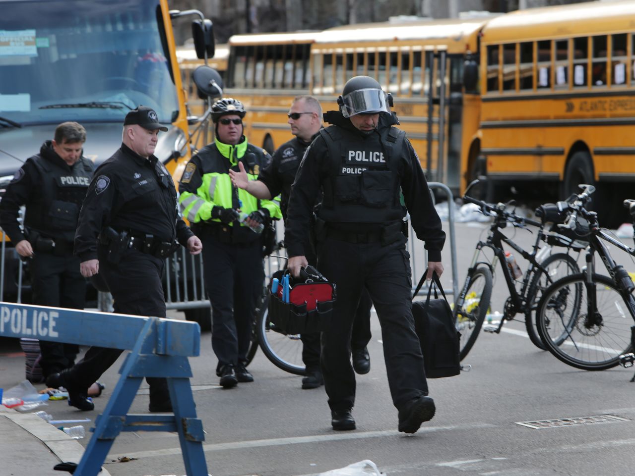 The Cambridge Police Department's bomb squad investigates unattended personal items left behind after the explosions.
