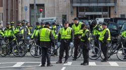 BOSTON - APRIL 15: Police officers lined Newbury Street following two explosions on Boylston Street in Boston near the finish line of the Boston Marathon. (Photo by Aram Boghosian for The Boston Globe via Getty Images)