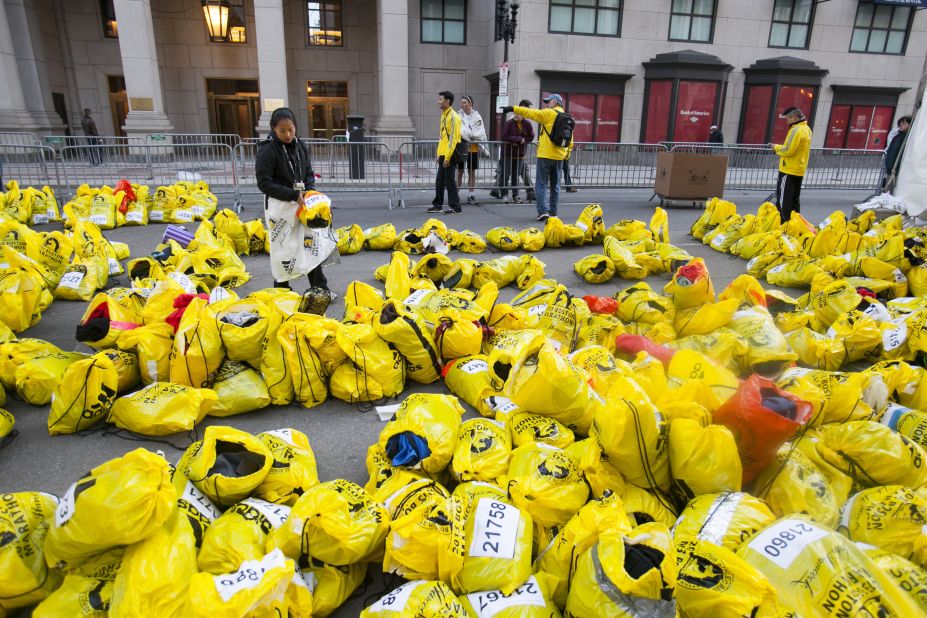 Unclaimed runners' bags fill an area near the marathon finish.