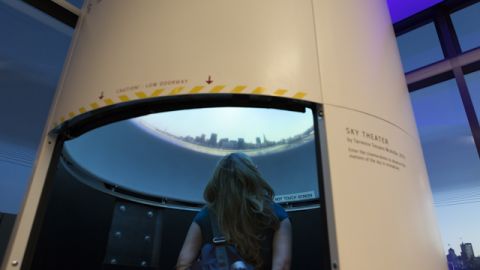 A guest checks out the Sky Theater exhibit at the new Exploratorium. 