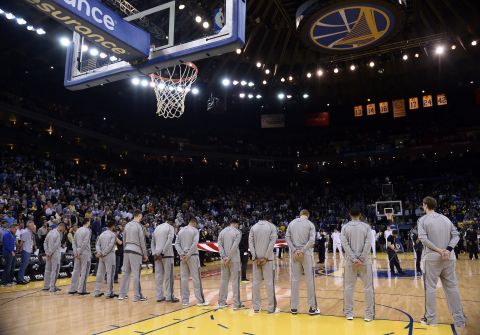 Players and fans observe a moment of silence before an NBA game in Oakland, California, on Aprl 15, 2013.
