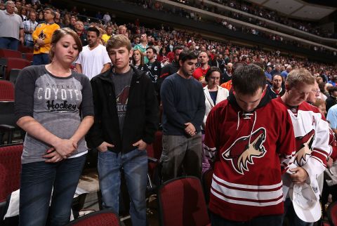 Hockey fans in Glendale, Arizona, pause for a moment of silence before a game on April 15, 2013.