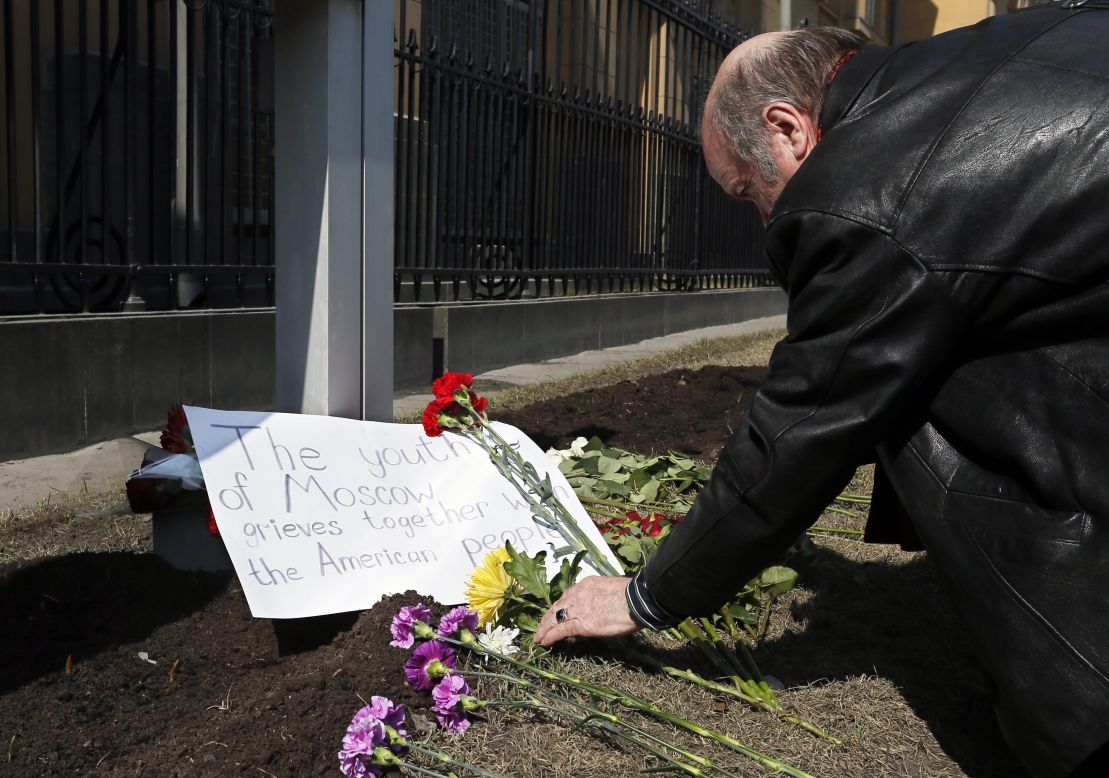 A man puts flowers near the U.S. Embassy in Moscow on Tuesday.