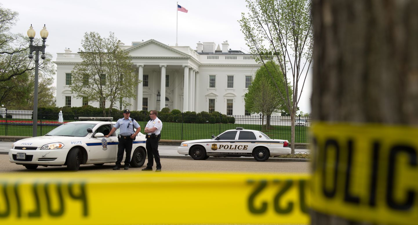 Police officers stand in front of the White House on Monday after the Secret Service heightened security.