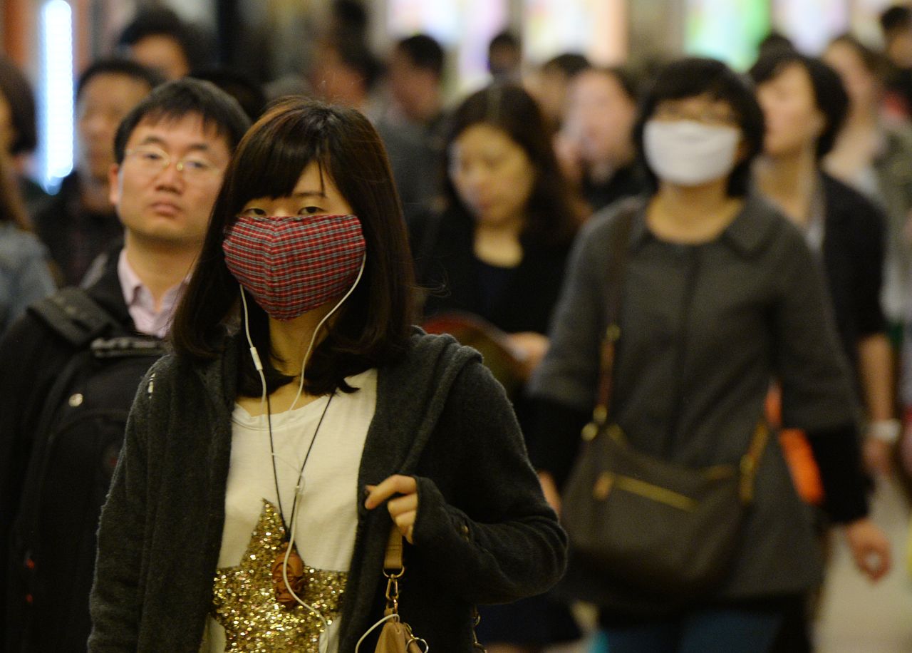Pedestrians in Shanghai wear face masks to protect themselves from  the H7N9 bird flu virus on Tuesday, April 16. 