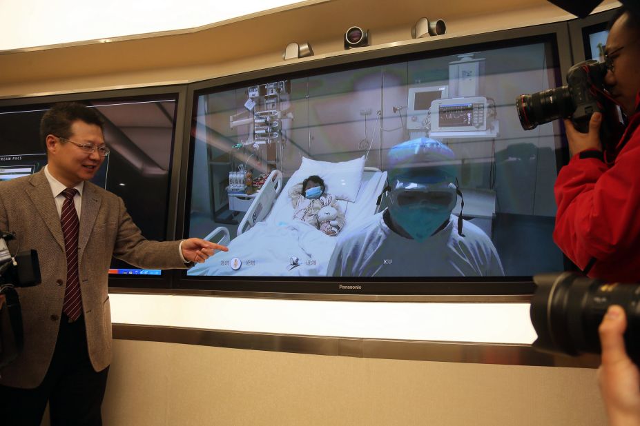 Cheng Jun, vice president of Beijing's Ditan hospital, shows a video of the first bird flu victim in intensive care  during a press conference on Saturday, April 13.