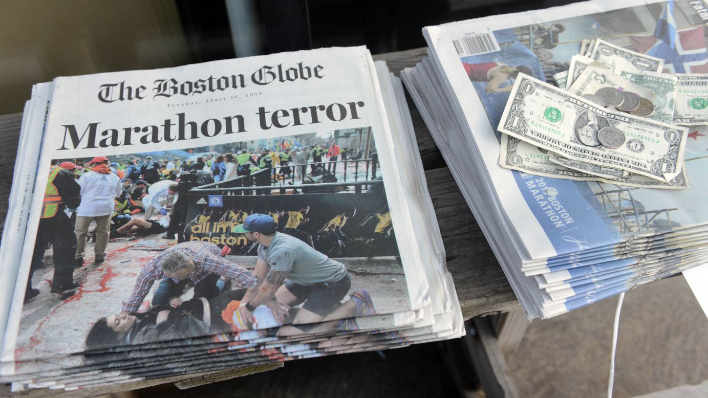 The bombings dominate the front pages of newspapers at a newsstand on Newbury Street in Boston.