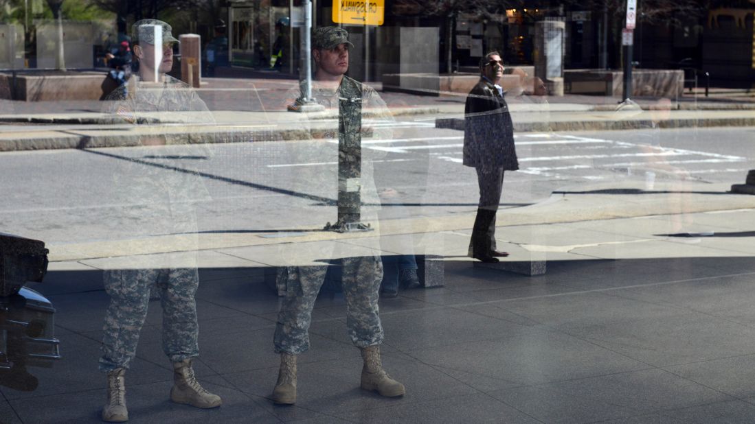 National Guardsmen look out from inside Boston's Back Bay Station on April 16.