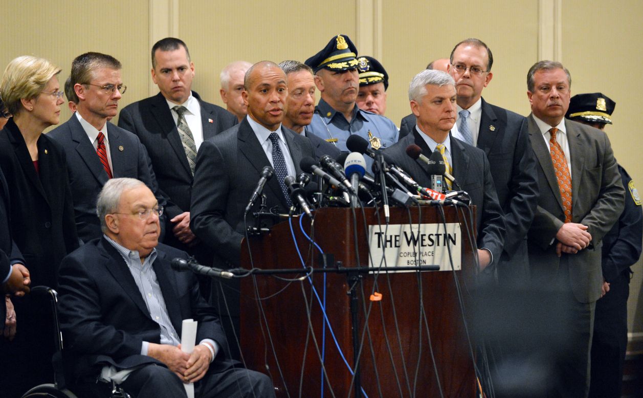 Massachusetts Gov. Deval Patrick speaks at a press conference about the bombings on Tuesday. From left, Sen. Elizabeth Warren, FBI Special Agent in charge of Boston Richard Deslauriers, and Boston Mayor Thomas Menino, seated at front left.