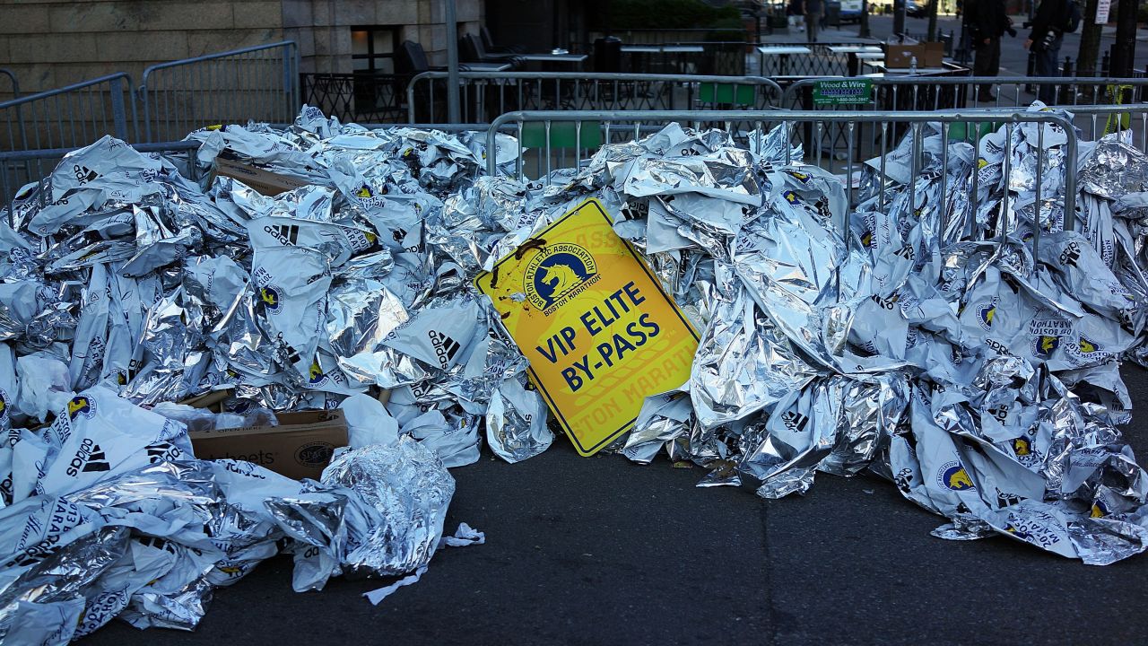 Unused thermal blankets for runners are piled high near the scene of the bombings on April 16.