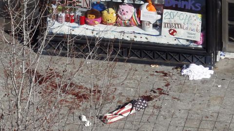 Blood is visible on a sidewalk in front of a Boston store on April 16.