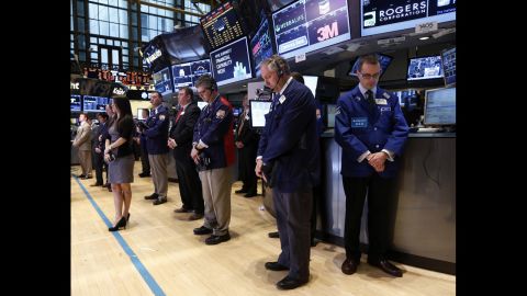 Traders at the New York Stock Exchange observe a moment of silence before the opening bell on April 16, 2013.