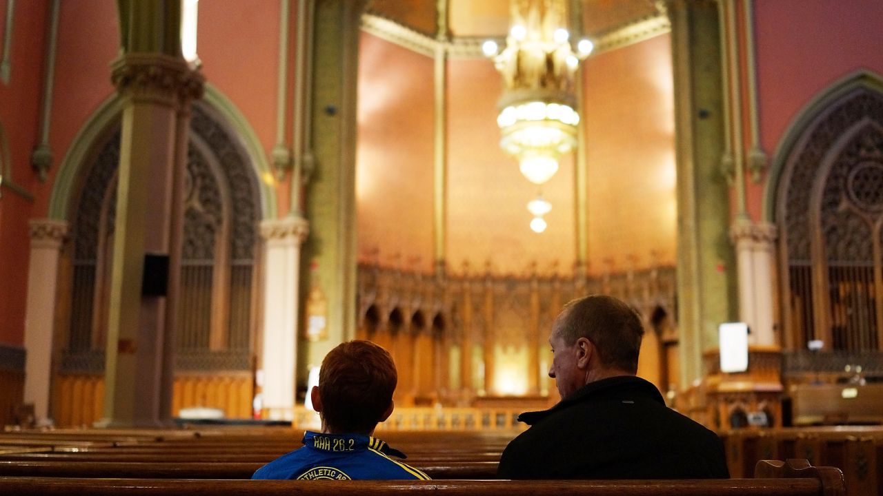 The city was quiet <a href="http://www.cnn.com/2013/04/16/us/gallery/boston-aftermath/index.html">the day after the tragedy.</a> Here, a young runner, left, sits in a church near the scene of the attack.