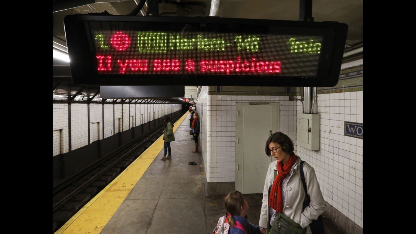 A message asking passengers to report suspicious activity flashes on an electronic sign inside a New York City subway station on Tuesday.