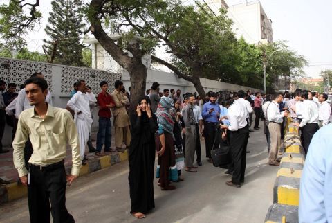 People evacuate buildings in Karachi, Pakistan, following a powerful earthquake near the border with Iran on Tuesday, April 16.