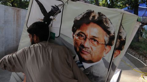 A supporter of former Pakistani president Pervez Musharraf places banners at the party office in Islamabad on April 16, 2013.
