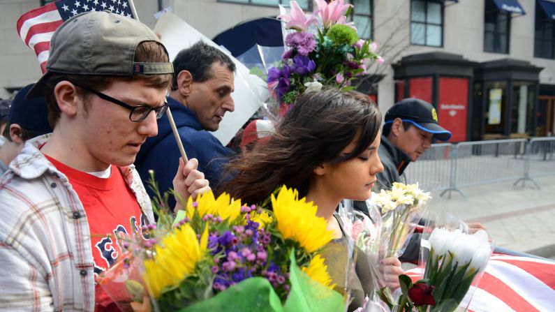 People walk along the barricade at Boylston Street on April 16, 2013.