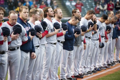 Members of the Boston Red Sox observe a moment of silence before their Major League Baseball game in Cleveland on April 16, 2013.
