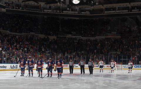 The New York Islanders and Florida Panthers stand for a moment of silence before an NHL hocky game in Uniondale, New York, on April 16, 2013.