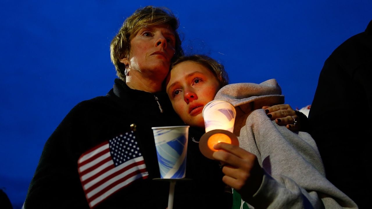 BOSTON, MA - APRIL 16: A young girl cries with her mother during the vigil for eight-year-old Martin Richard, from Dorchester, who was killed by an explosion near the finish line of the Boston Marathon on April 16, 2013 at Garvey Park in Boston, Massachusetts. The twin bombings resulted in the deaths of three people and hospitalized at least 128. The bombings at the 116-year-old Boston race resulted in heightened security across the nation with cancellations of many professional sporting events as authorities search for a motive to the violence. (Photo by Jared Wickerham/Getty Images)