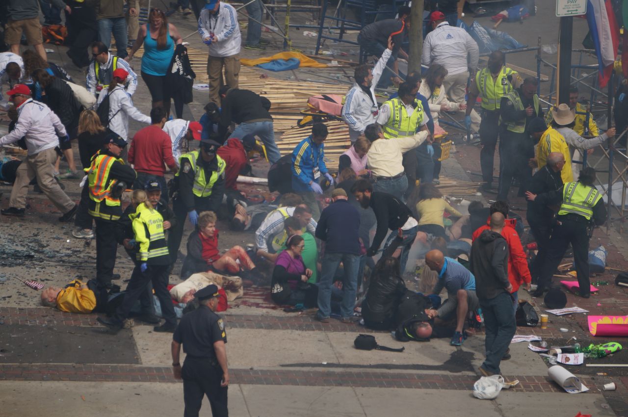 Injured people lie on the ground.