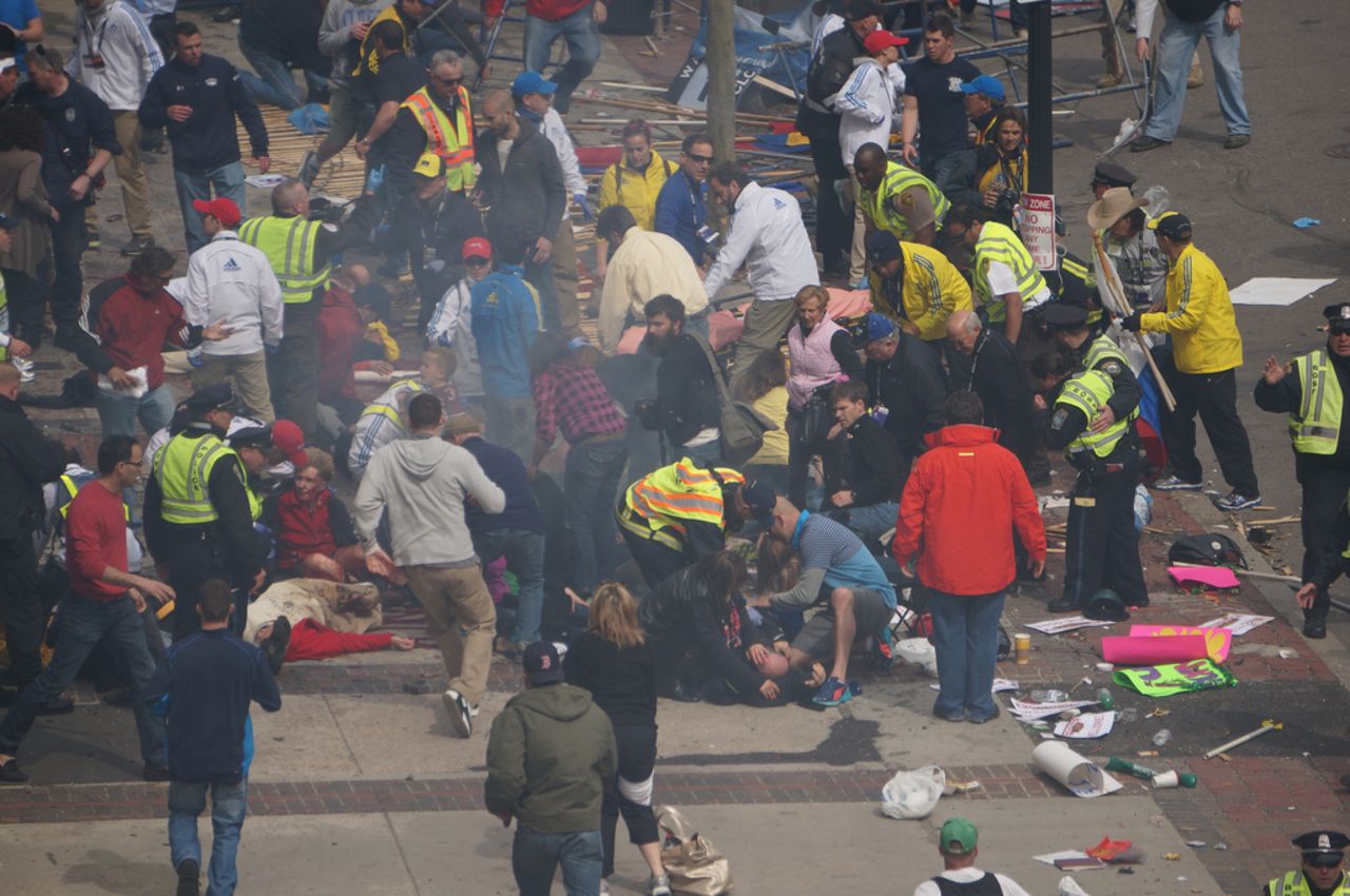 Officers and others help the injured.