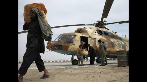 Pakistani army officials unload relief goods Wednesday in Mashkell.