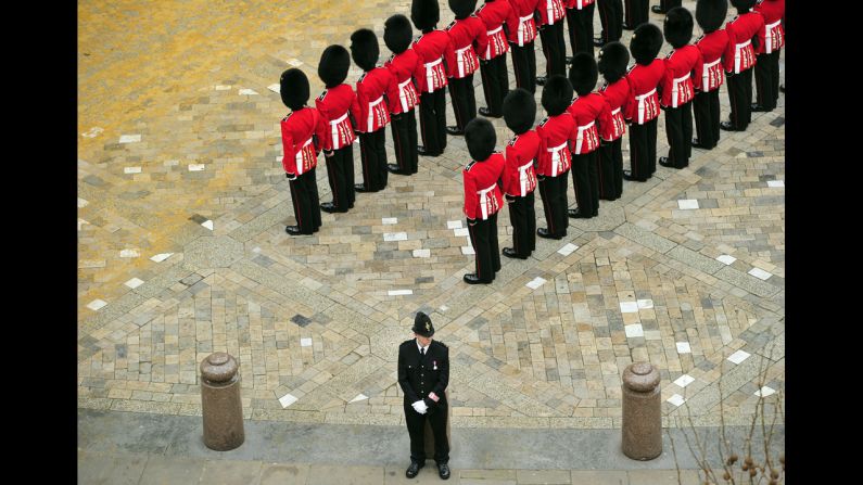 Guardsmen stand to attention outside St Paul's Cathedral.