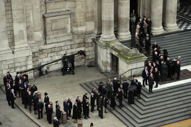 Mourners wait outside St Paul's Cathedral to attend Thatcher's ceremonial funeral.