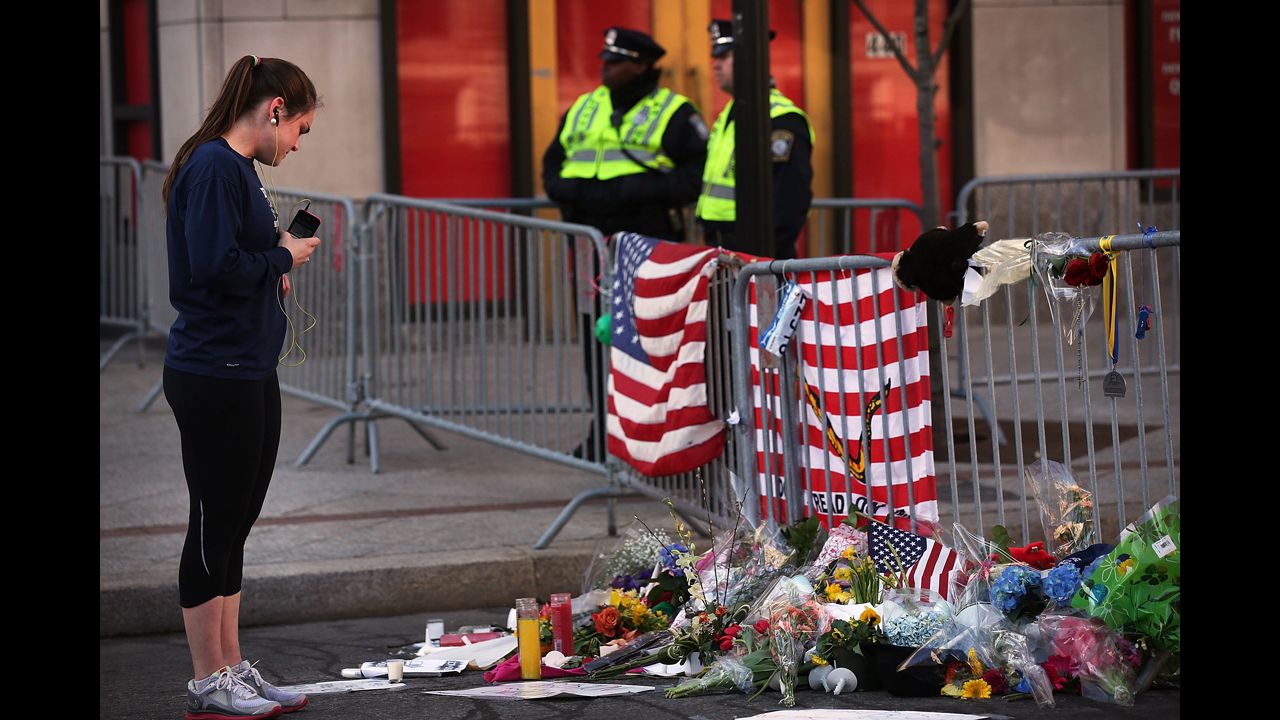 A woman looks at memorials left at the scene of the attack.
