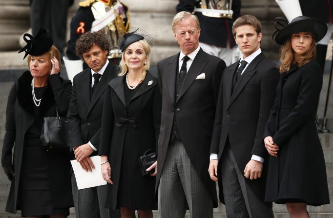 Carol Thatcher, Marco Grass, Sarah Thatcher, Mark Thatcher, Michael Thatcher and Amanda Thatcher watch from the steps of St. Paul's Cathedral as the coffin is placed in the hearse after the funeral.