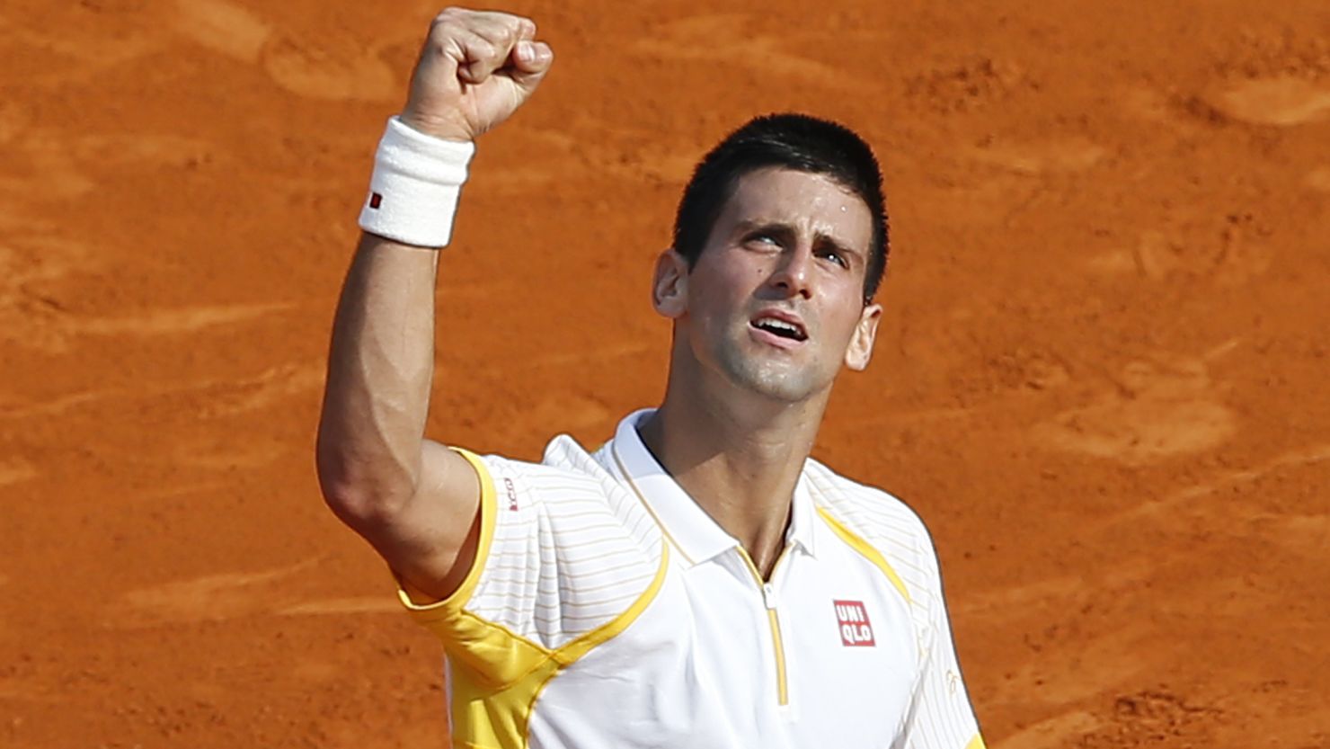 Novak Djokovic punches the air in relief after winning his second round match at the Monte Carlo Masters