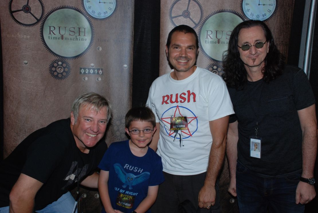 Ed Stenger and his son Zach meet Alex Lifeson, left and Geddy Lee, right, in Toronto, Canada.