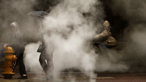 People make their way along Champa Street in downtown Denver during a spring storm on Wednesday, April 17.