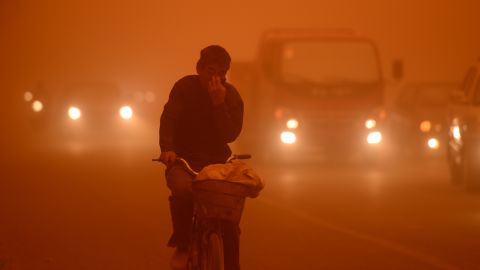 A man rides a bike during a heavy sandstorm in Yecheng county, northwest China's Xinjiang Uygur Autonomous Region, on Tuesday, April 16.