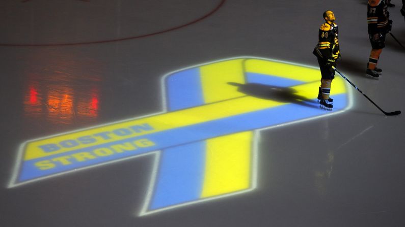 Dennis Seidenberg of the Boston Bruins observes a moment of silence before the start of an NHL hockey game in Boston on April 17, 2013. It was the first sporting event held in the city after the bombings.