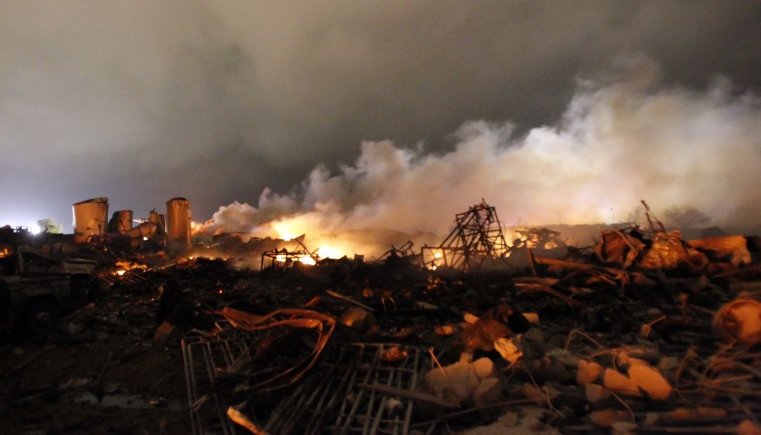 Remains of the fertilizer plant burn in the early morning after the explosion.
