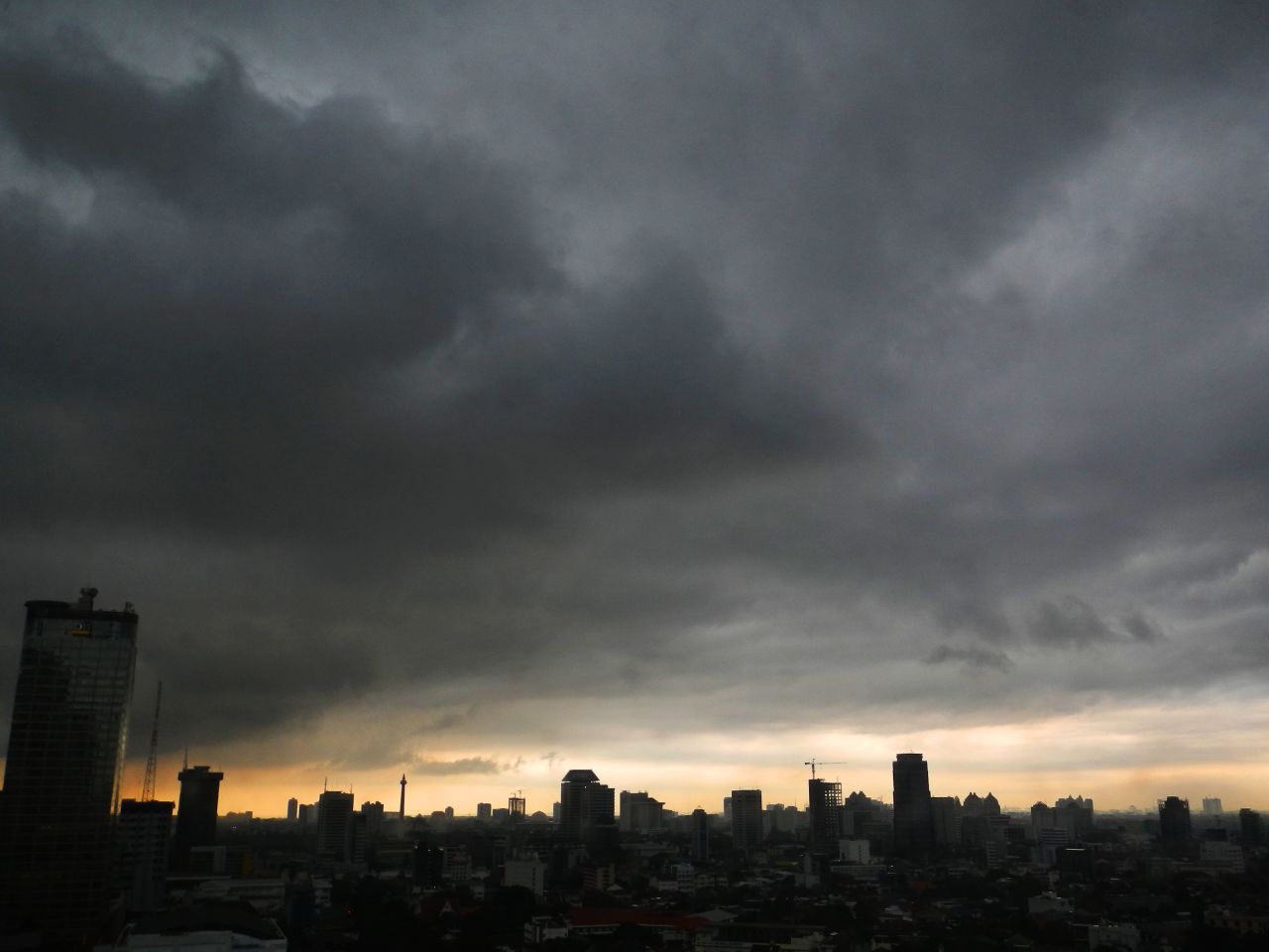 Dark clouds hang over the Indonesian capital of Jakarta on April 18.