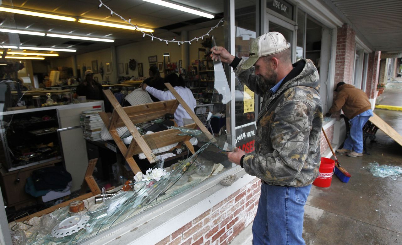 Brandon Smith removes broken glass from the West Thrift Shop.
