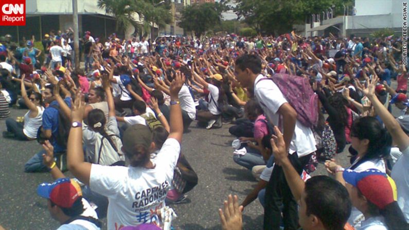 Also in Barquisimeto, medical student <a href="index.php?page=&url=http%3A%2F%2Fireport.cnn.com%2Fdocs%2FDOC-958057">Rebeca Asuaje</a> captured this image of opposition protesters raising their arms to dispute the results.