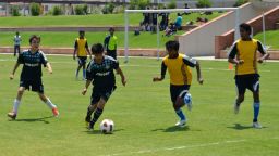 Young, aspiring footballers play a match at the Baichung Bhutia Football School at the Jaypee Sports Complex, Greater Noida, New Delhi in May 2012. Many youngsters are avid supporters of European and South American teams, but few dream of playing in their home country of India.