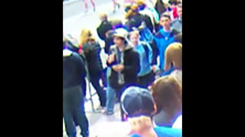 Suspect 2 walks through the crowd. <a href="index.php?page=&url=http%3A%2F%2Fwww.cnn.com%2FSPECIALS%2Fus%2Fboston-bombings-galleries%2Findex.html">See all photography related to the Boston bombings.</a>