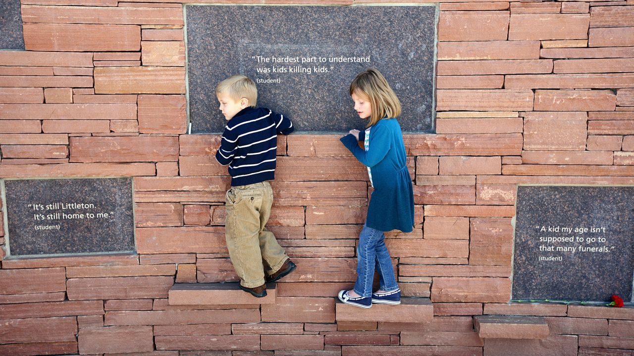 Children, a sister and  brother, walk along the Columbine Memorial at the Columbine Memorial Park in Littleton, Colorado. 