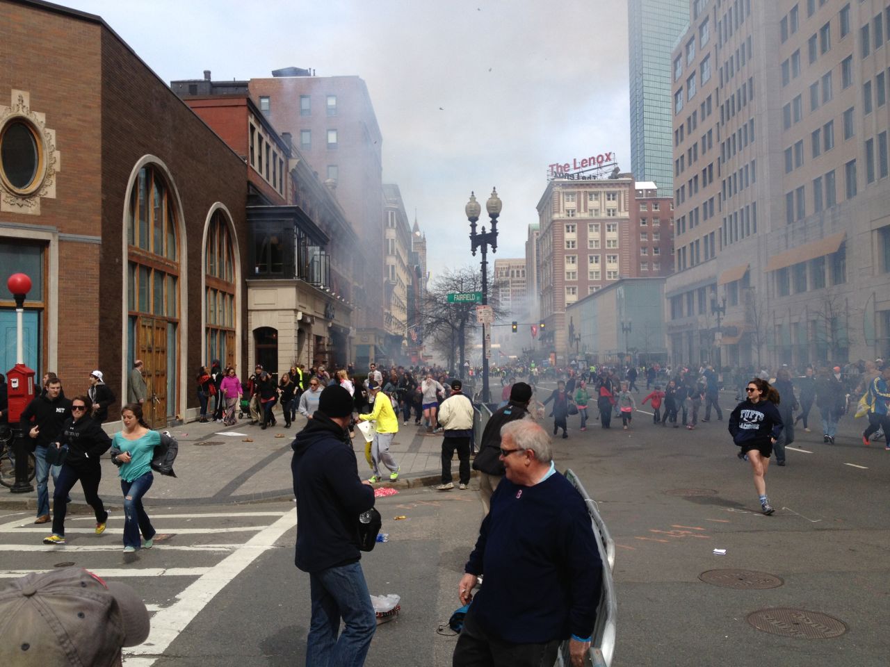 FBI Suspect No. 2, later said to be Dzhokhar Tsarnaev, is apparently seen in this picture, far left in white cap. The photo was taken by Boston Marathon runner David Green at the scene of the bombings.
