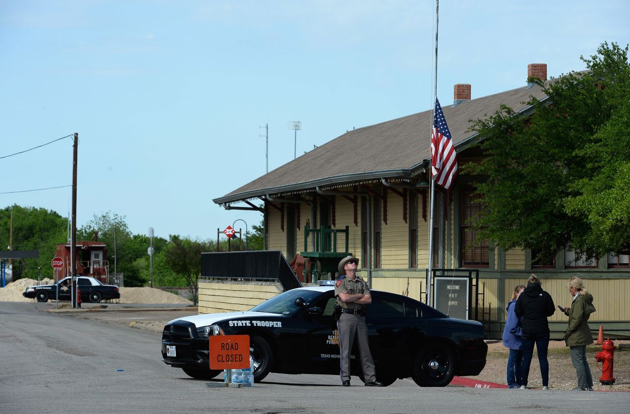 A Texas State Trooper stops people from entering a neighborhood near the plant.