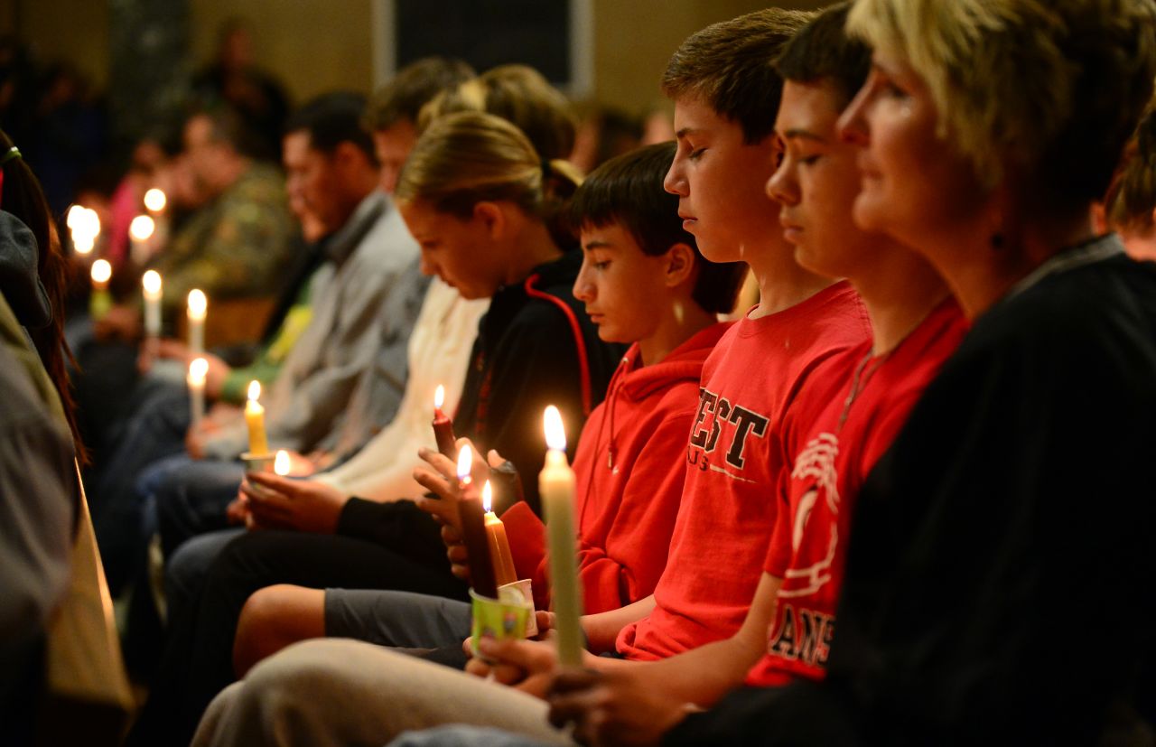 People gather for a candlelight vigil at a church in West on April 18.