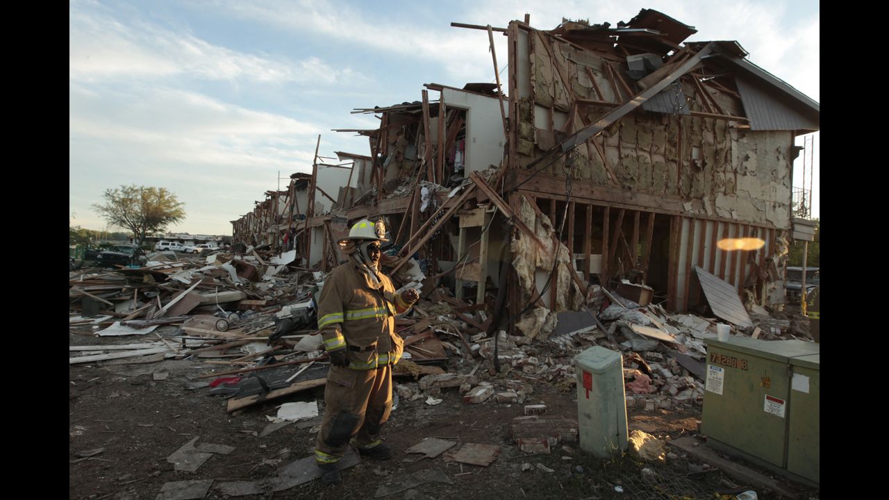 A Valley Mills Fire Department firefighter walks through the remains of an apartment complex next to the fertilizer plant.